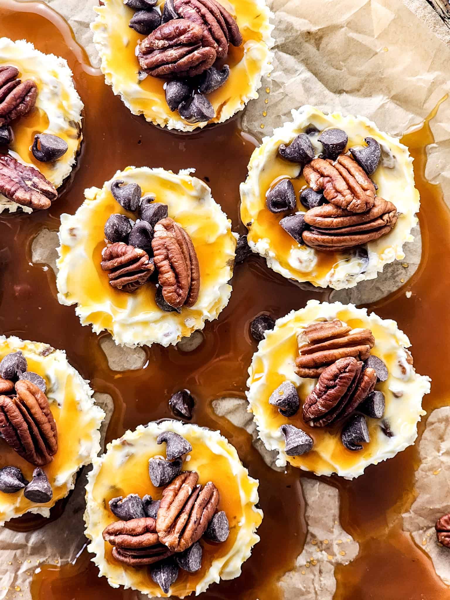 Delicious no-bake mini turtle cheesecakes with caramel drizzle and pecans.