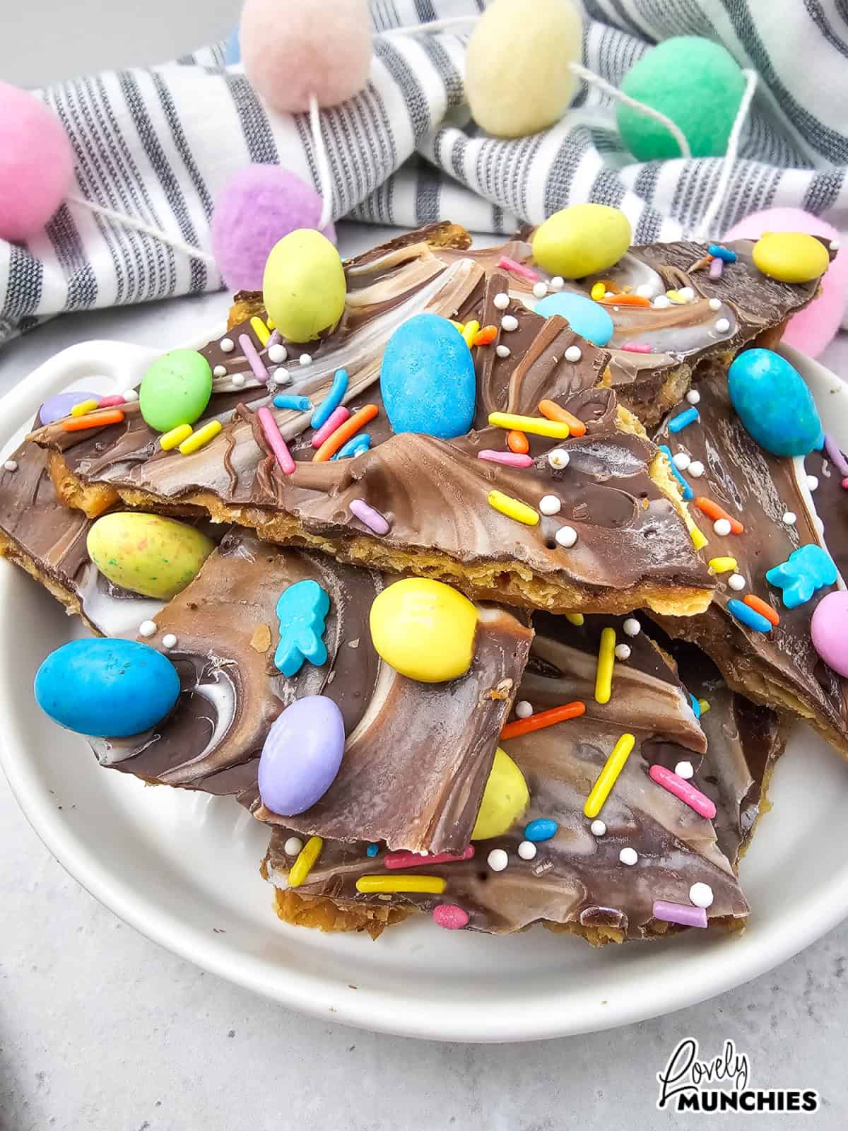 A sweet and salty Easter cracker bark with chocolate, M&Ms, Robin Eggs, and festive sprinkles.